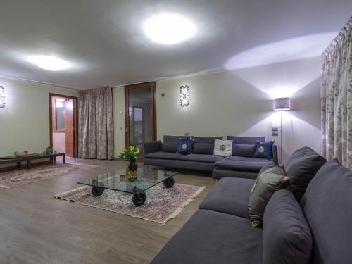a living room with a couch and a table at Mamma Ciccia - ecofriendly villa on Lake Como in Malgrate