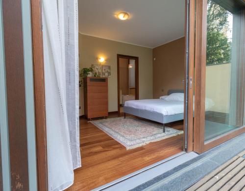 a view of a bedroom with a bed and a window at Mamma Ciccia - ecofriendly villa on Lake Como in Malgrate