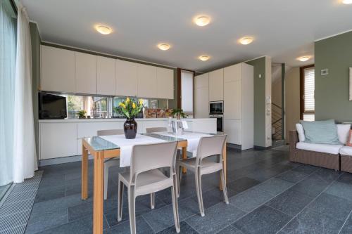 a kitchen and dining room with a table and chairs at Mamma Ciccia - ecofriendly villa on Lake Como in Malgrate