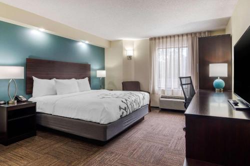 a large hotel room with a bed and a television at Sleep Inn Marietta-Atlanta near Ballpark-Galleria in Marietta