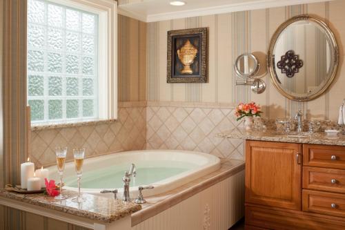 a bathroom with a tub and a window and a sink at Arrowhead Inn in Durham