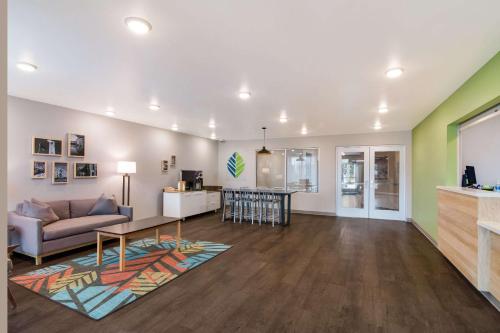 a living room with a couch and a table at WoodSpring Suites Morrisville - Raleigh Durham Airport in Morrisville