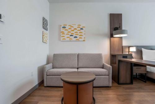 a living room with a couch and a table at Comfort Inn & Suites Panama City Beach - Pier Park Area in Panama City Beach
