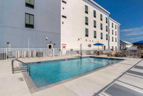 a swimming pool in front of a building at Comfort Inn & Suites Panama City Beach - Pier Park Area in Panama City Beach