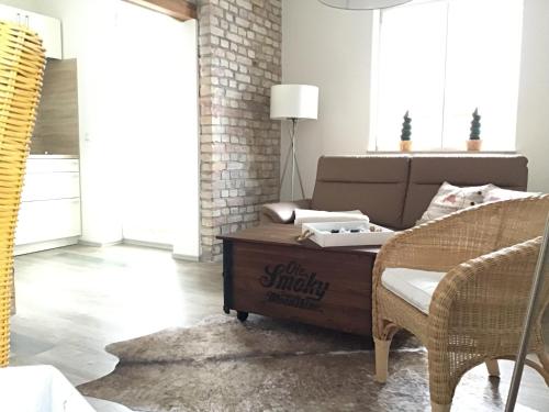 a living room with a couch and a table at Appartementhaus Warnemünde in Warnemünde