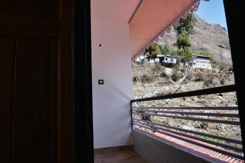a room with a window with a view of a mountain at Rufina Lachung Kunga in Lachung