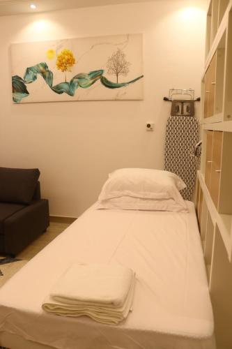 a bed in a room with a painting on the wall at ZAPBED House - Luxury Holiday Homes in Yas Island in Abu Dhabi