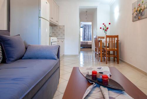 a living room with a blue couch and a table at Ethereal Villas Lefkas in Nydri