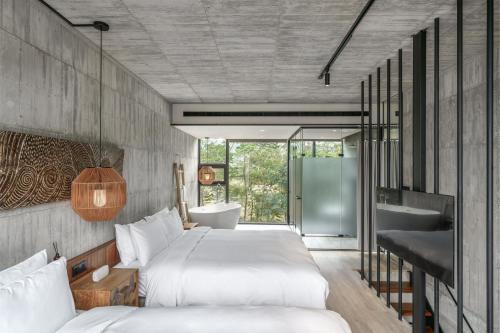 a bedroom with two beds and a tub and a sink at Deer Chaser Hotel in Yuchi