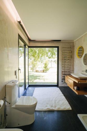 a bathroom with a toilet and a sink at Quinta do Pomar Maior in Arouca