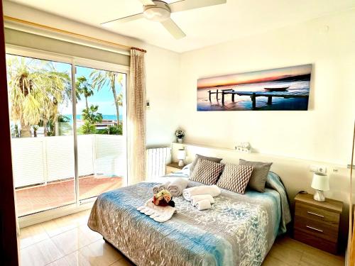 a bedroom with a bed with a teddy bear on it at Sitges Seafront Ribera Apartment in Sitges