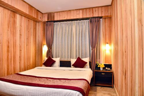 a hotel room with a bed and a window at Rufina Lachung Kunga in Lachung