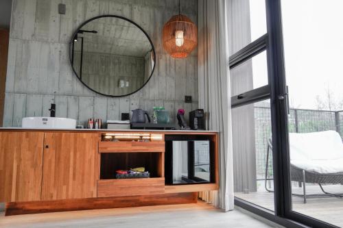 a bathroom with a mirror and a wooden cabinet at Deer Chaser Hotel in Yuchi