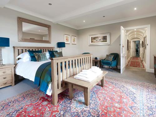 a bedroom with a bed and a table and a chair at Craggan in Ballater