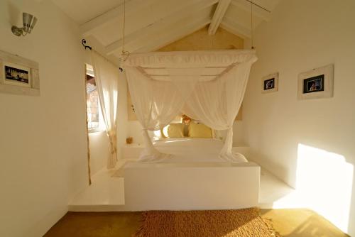 a bedroom with a bed with a canopy at Spinguera Ecolodge in Espingueira