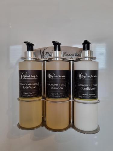 a group of three perfume bottles sitting next to each other at Craggan in Ballater