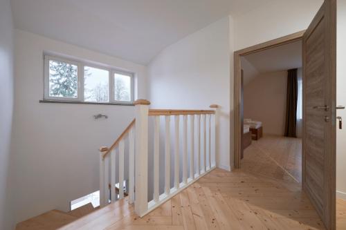 a hallway with a staircase and a window at Jonavos alpakų svečių namai in Jonava