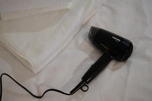 a black hair dryer sitting on a table at Jonavos alpakų svečių namai in Jonava