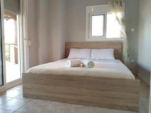 a bed with two towels on it in a bedroom at STELLAS HOUSE POLYCHRONO in Polykhrono