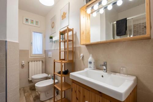 a bathroom with a sink and a toilet and a mirror at Casa al 4 in Florence