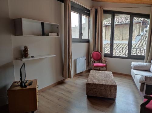 a living room with a couch and a chair at APT 3 Àtic acollidor al Centre de Vic - APTGARBI in Vic