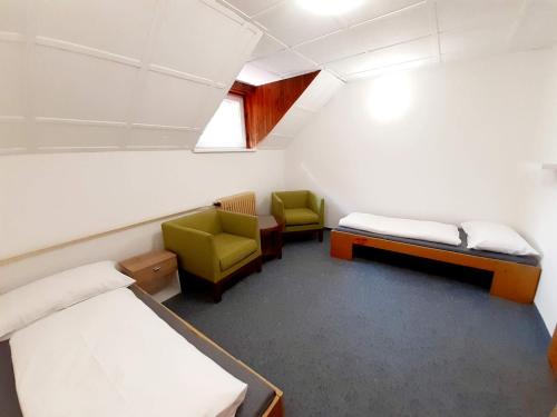 a hospital room with two beds and two chairs at Chata JedlOvka in Jiřetín pod Jedlovou