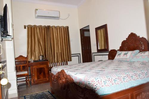 a bedroom with a bed and a dresser in it at Hotel MSD Niwas in Mandāwa