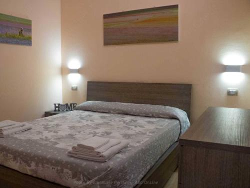 a bedroom with a bed with towels on it at La Cascina delle Viole in Norcia