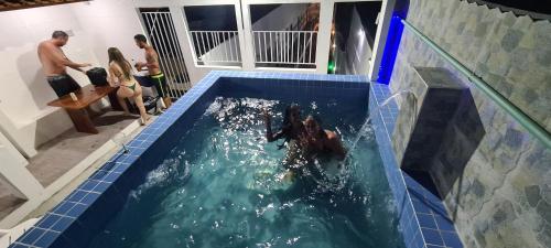 a group of people in a swimming pool at Hotel Castelo La Paloma in Gamboa
