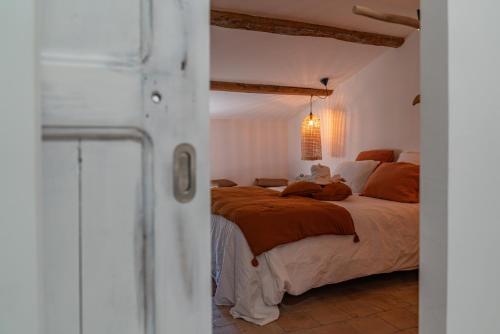 a bedroom with a large bed in a room at La Maison de Lyna - Suites de charme intra-muros avec parking & autonomie in Aigues-Mortes