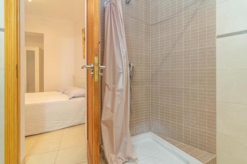 a bathroom with a shower with a glass door at Casa Nord 10Pax in Caimari