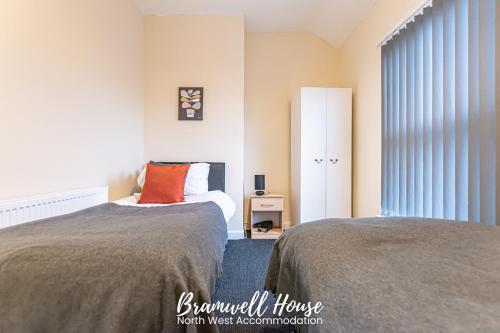 a bedroom with two beds and a window at St Helens Contractor Accommodation in Saint Helens