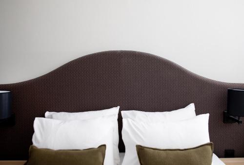 a bedroom with two pillows and a large headboard at Bob W Sentralen in Oslo