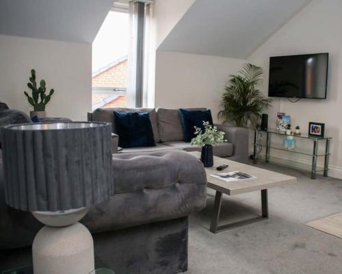 a living room with a couch and a coffee table at Luxe Living Guest House-Sleeps 6 -Family Friendly-Private Parking-Wifi-City-Beach in Swansea