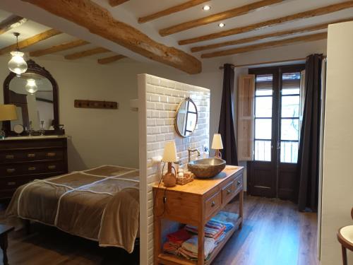 a bedroom with a bed and a dresser and a mirror at Can vinyals 1979 in La Pobla de Cérvoles