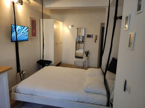 a bedroom with a bed and a television in it at Appartamento Galgano Prato centro in Prato