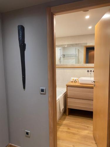 a bathroom with a door with a knife hanging on the wall at Arthur Properties Rue d'Antibes in Cannes