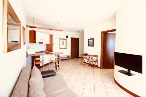 a living room with a couch and a dining room at Boka Residence 8 in Herceg-Novi