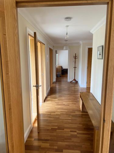 a hallway of a home with a wooden floor at Rohallian in Stanley