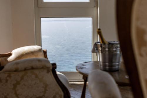 a room with a window and a chair and a table at Classique in Lazise