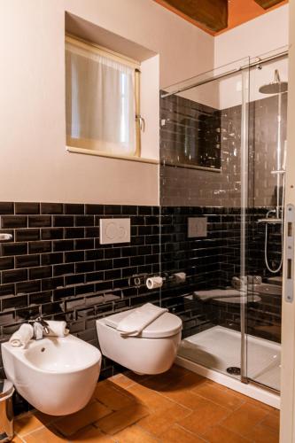 a bathroom with a sink and a toilet and a shower at Classique in Lazise