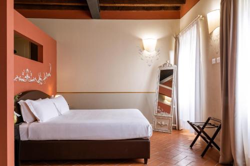 a bedroom with a white bed and a window at Classique in Lazise