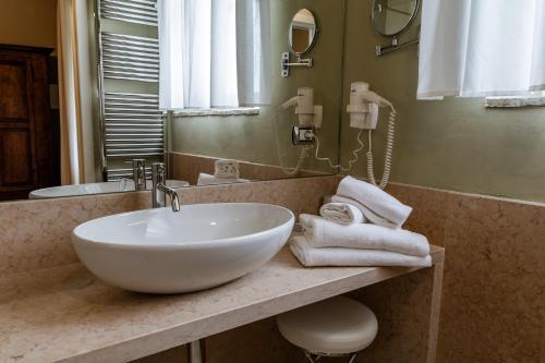 a bathroom with a white bowl sink on a counter at Classique in Lazise