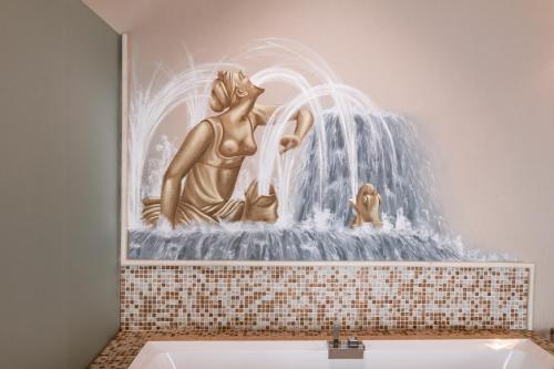 a painting of a mermaid sitting in a fountain at Classique in Lazise