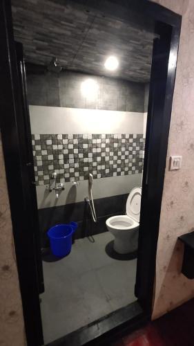 a bathroom with a toilet and a sink at Beach Paradise Day Cruise Houseboat in Alleppey