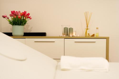 a room with a counter with a vase of flowers at ARIA - Villa di Campagna in Montecorvino Rovella