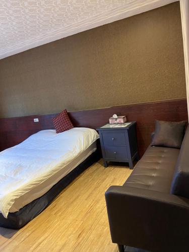 Una cama o camas en una habitación de 橙橙民宿瑞芳車站