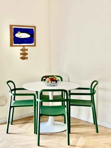 a table and chairs with a bowl of fruit on it at Little House 5 Terre in La Spezia