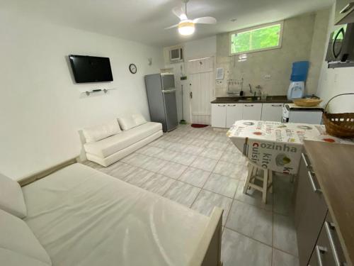 a kitchen and living room with a couch and a table at Condominio Aquarius 1 in Angra dos Reis