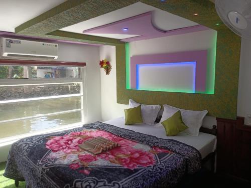 a bedroom with a bed with flowers on it at Beach Paradise Day Cruise Houseboat in Alleppey